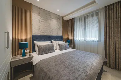 a bedroom with a large bed and a window at Kalamper Apartments in Dobra Voda