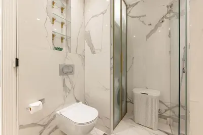 a bathroom with a toilet and a glass shower at Kotor Lux apartments and rooms in Kotor