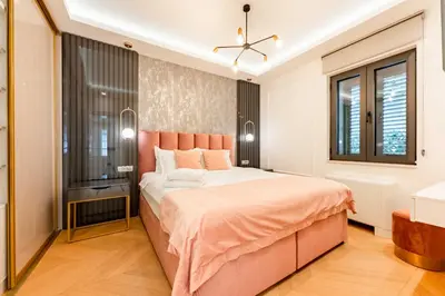 a bedroom with a large bed and a window at Kotor Lux apartments and rooms in Kotor
