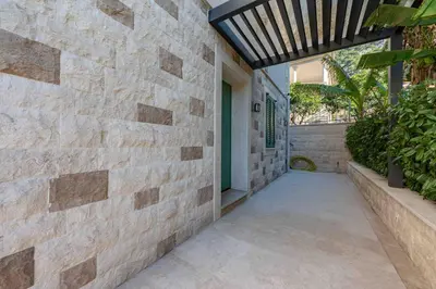a walkway leading to the front door of a house at Kotor Lux apartments and rooms in Kotor