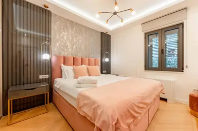 a bedroom with a large bed with an orange headboard at Kotor Lux apartments and rooms in Kotor