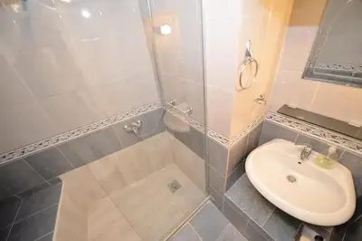 a bathroom with a sink and a shower and a toilet at Cosy front line apt with sea access at your door step in Kotor