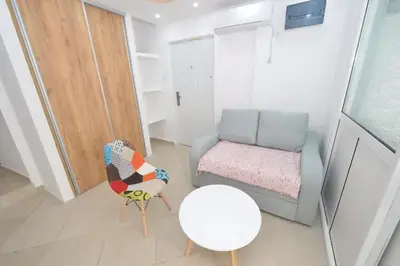 a living room with a couch and a table and a chair at Cosy front line apt with sea access at your door step in Kotor
