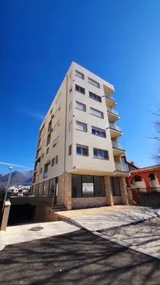 a tall white building with a lot of windows at Aleksandar First Sea Line Apartment in Bar