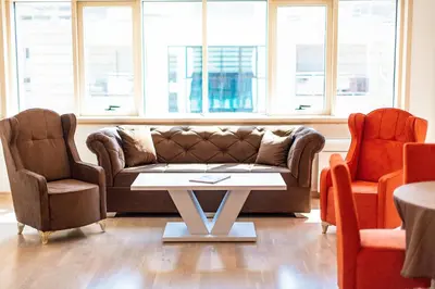 a living room with a couch and two chairs at Montesun Fontana Apartments in Budva