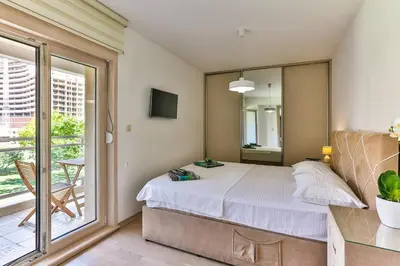 a bedroom with a bed and a balcony at Montesun Fontana Apartments in Budva