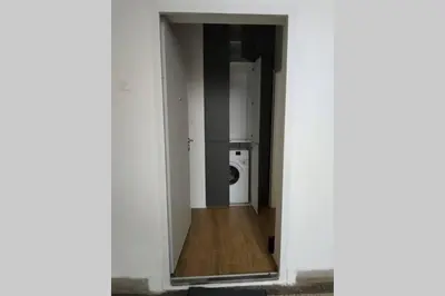 a doorway to a laundry room with a washing machine at MILLENNIUM bridge cozy apartment TOP location in Podgorica