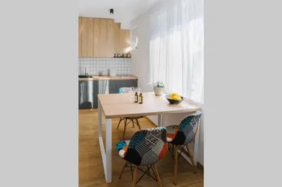 a kitchen with a table and two chairs at MILLENNIUM bridge cozy apartment TOP location in Podgorica