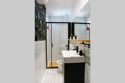 a bathroom with a sink and a toilet at MILLENNIUM bridge cozy apartment TOP location in Podgorica