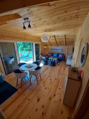 a living room with a table and chairs in a cabin at Mery Ada House in Ulcinj