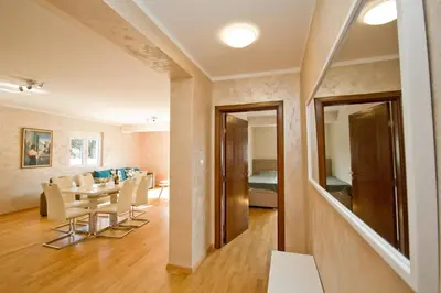 a dining room and living room with a table and chairs at Lux Apartment 