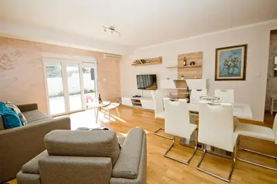 a living room with a couch and a table and chairs at Lux Apartment 