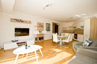 a living room with a couch and a table at Lux Apartment 