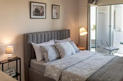 a bedroom with a large bed with pillows at Les appartements Privés Bar in Bar