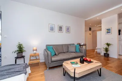 a living room with a couch and a coffee table at Les appartements Privés Bar in Bar