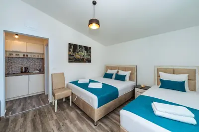 a hotel room with two beds and a kitchen at Altea in Bar, Susanj