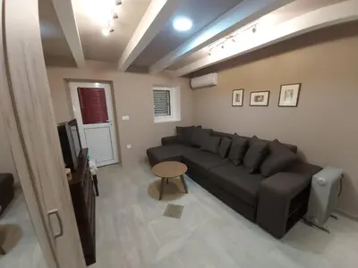 a living room with a black couch and a table at Magnolia Lux Apartments in Budva