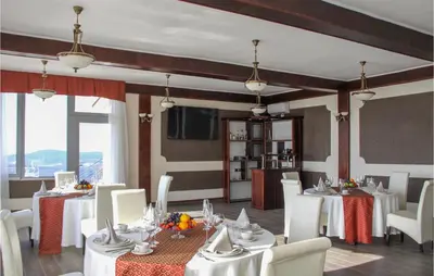 a dining room with white tables and white chairs at Awesome Home In Kotor in Kotor