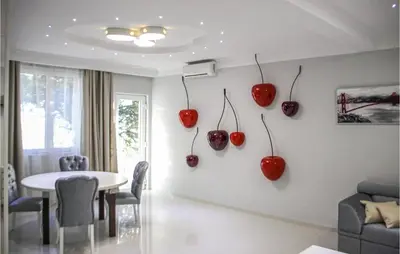 a dining room with red apples hanging on the wall at Awesome Home In Kotor in Kotor