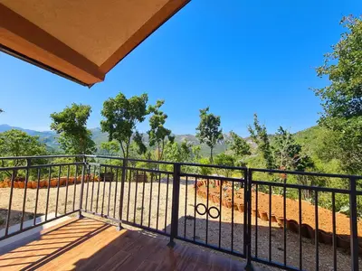 a balcony with a view of the mountains at S&M Apartments in Rijeka Crnojevića