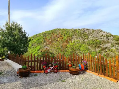 a wooden fence with two bikes and potted plants at S&M Apartments in Rijeka Crnojevića
