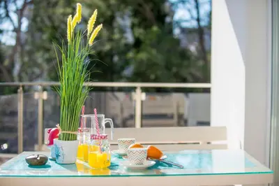 a glass table with a tray of oranges and juice at HAPPY HOME in Tivat