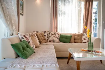 a living room with a couch and a table at HAPPY HOME in Tivat