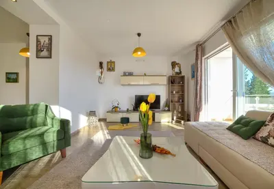 a living room with a couch and a table at HAPPY HOME in Tivat