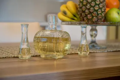 three glass vases sitting on a table with fruit at HAPPY HOME in Tivat