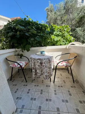 a table and two chairs sitting on a balcony at Apartments Kuljaca in Budva