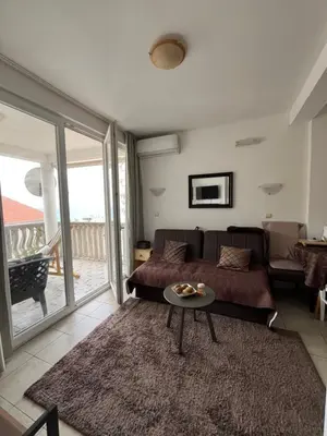 a living room with a couch and a table at Apartments Kuljaca in Budva