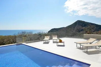 a villa with a swimming pool with a view of the ocean at Villa Zen Hill in Petrovac na Moru
