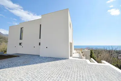 a white house with a view of the ocean at Villa Zen Hill in Petrovac na Moru