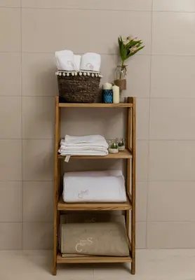 a towel shelf in a bathroom with towels at Carsko Selo Blizikuce in Budva