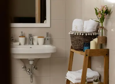 a bathroom with a sink and a basket of towels at Carsko Selo Blizikuce in Budva