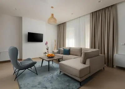 a living room with a couch and a chair at Carsko Selo Blizikuce in Budva