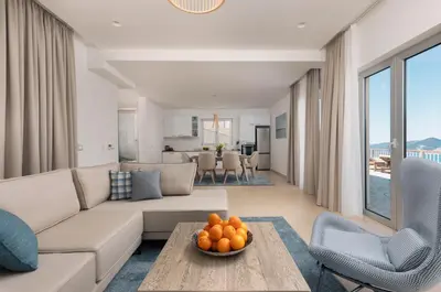 a living room with a couch and a table at Carsko Selo Blizikuce in Budva