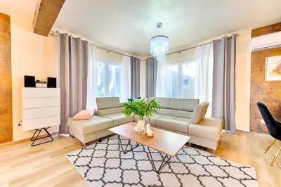 a living room with a couch and a table at Villa Panorama Hill in Dobra Voda
