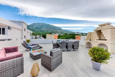 a patio with furniture and a view of a mountain at Villa Panorama Hill in Dobra Voda
