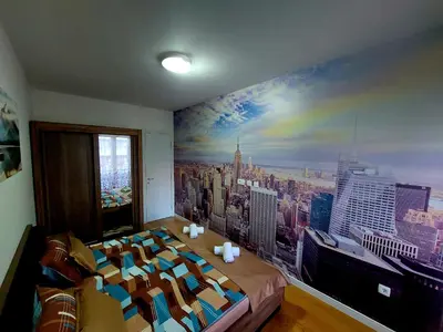 a bedroom with a large mural of a city at New York - Central Point in Podgorica