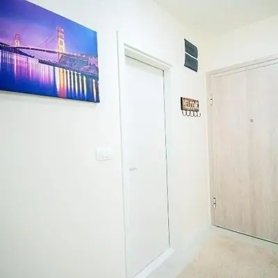 a white room with a painting on the wall at New York - Central Point in Podgorica