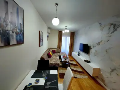 a living room with a couch and a table at New York - Central Point in Podgorica