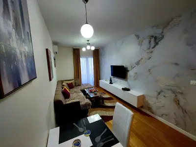 a living room with a marble wall at New York - Central Point in Podgorica