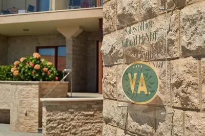 a sign on a stone wall in front of a building at Villa Allende in Budva