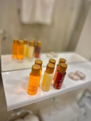 a shelf with several bottles of oils on it at Villa Allende in Budva