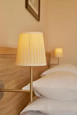 a lamp sitting on the floor next to a bed at Villa Allende in Budva