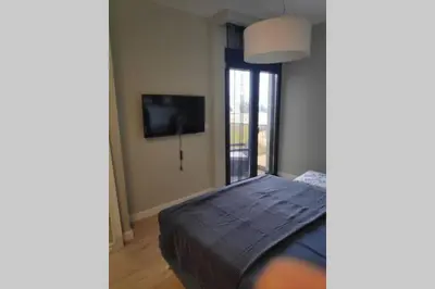a bedroom with a bed and a flat screen tv at Soho City Apartment with Garage in Bar