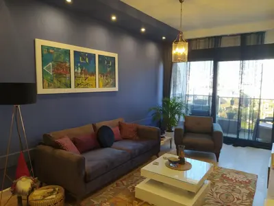 a living room with a couch and a table at Soho City Apartment with Garage in Bar