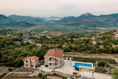 an aerial view of a house with a pool at Apartments and Winery Djukovic in Virpazar