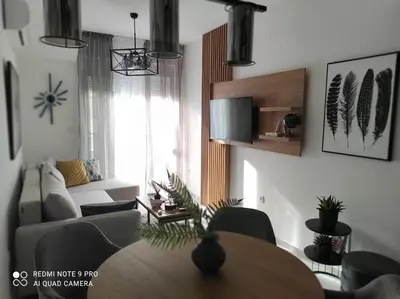 a living room with a table and a couch at Blue berry apart in Budva